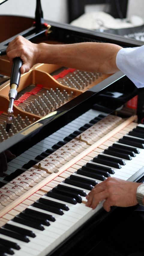 Pianio being tuned